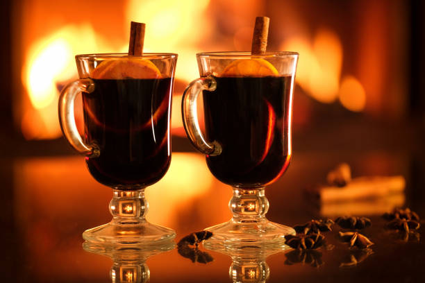 istock Two glasses with mulled wine on the fireplace
 background. 1357263548