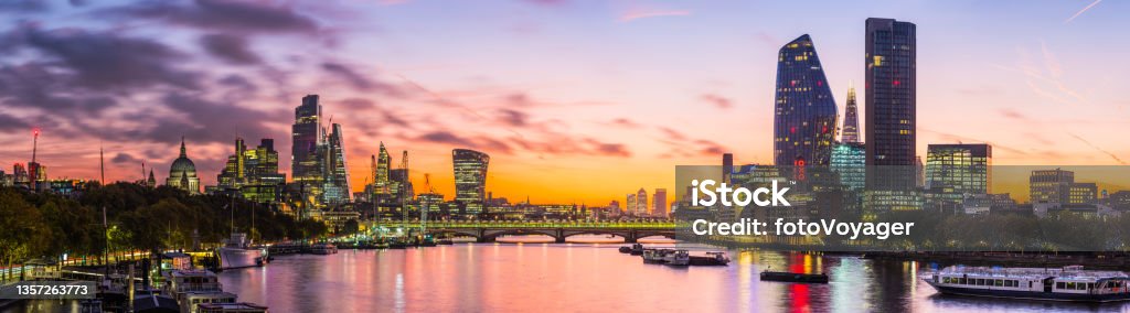 London dawn over City skyscrapers St Pauls Thames skyline panorama The iconic dome of St. Paul’s Cathedral, the glittering spires of the City skyscrapers and the futuristic towers of the South Bank overlooking the River Thames illuminated before sunrise in the heart of London, the UK’s vibrant capital city. London - England Stock Photo