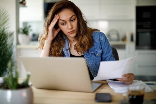 istock Worried young woman working at home 1357264727