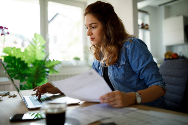 istock Serious young woman working at home 1357264738