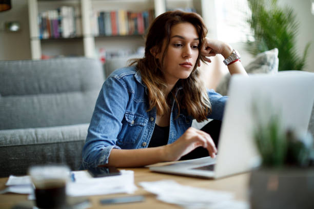 istock Young woman having video call on laptop computer at home 1357265467