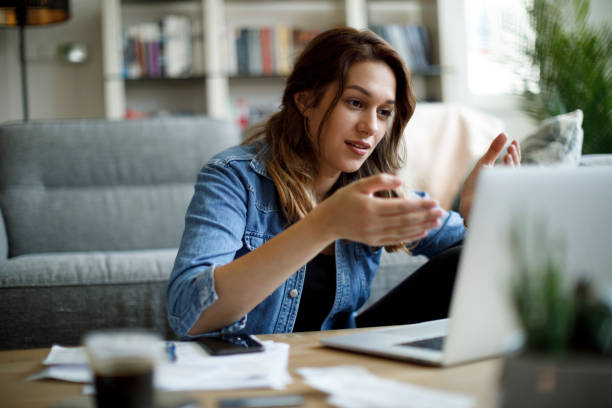 istock Young woman having video call on laptop computer at home 1357265491