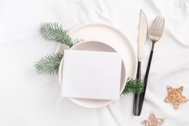 istock Christmas table setting for holiday dinner top view. Mockup paper blank with space for text. 1357265735