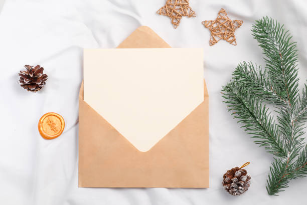 istock open craft envelope with gift card and christmas fir tree on textile 1357266813