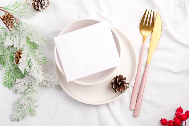 istock Christmas table setting for holiday dinner top view. Mockup paper blank with space for text. 1357266984