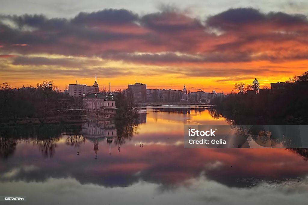 View of cityscape in the evening. Church of Blessed Xenia of St. Petersburg (left) on the riverbank of the river Southern Bug in Vinnytsia, Ukraine. Dramatic view Vinnytsia Stock Photo