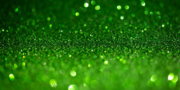 istock Dark green glitter lights. Shiny sparkles, bokeh effects, glowing surface. Selective focus, christmas abstract banner, background 1357268824