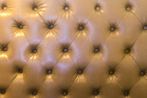 istock Light Brown closeup leather sofa chair texture bottons 1357269208