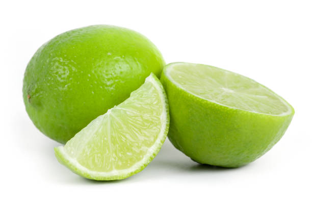 istock Limes with slices isolated on white background 1357270221