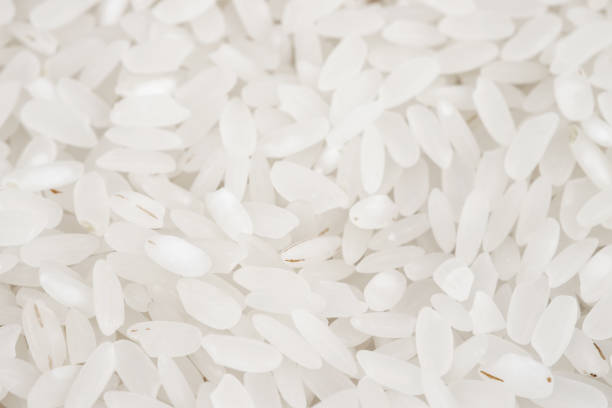 istock White long rice background, uncooked raw cereals, macro closeup 1357270272