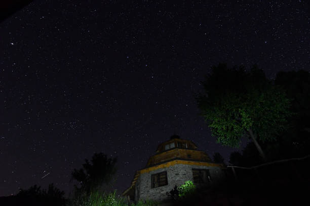 istock Night starry sky in the mountain village. 1357270448