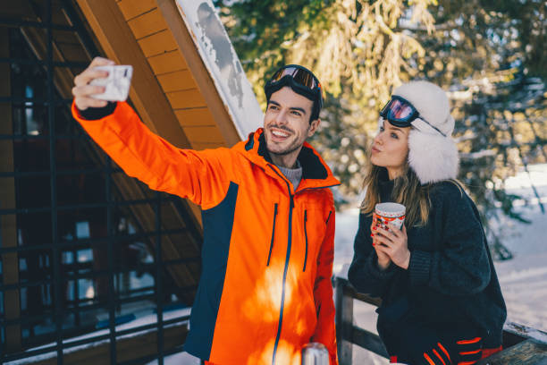 istock Couple on winter holiday taking selfie 1357273584