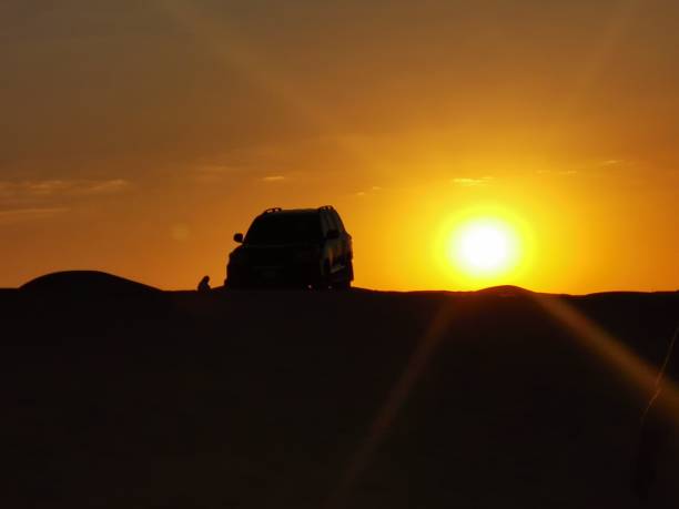istock sunset with car in the desert 1357275977