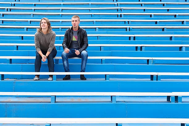 Couple on empty sports tribune