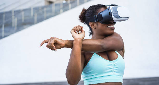 istock Fit african woman wearing virtual reality headset during sport workout routine - Focus on vr goggles 1357277390