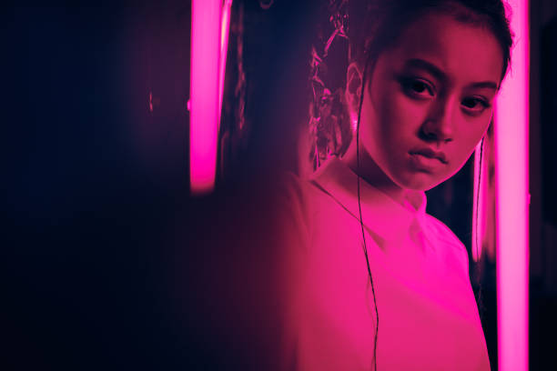 Teenager in neon light portrait stock photo