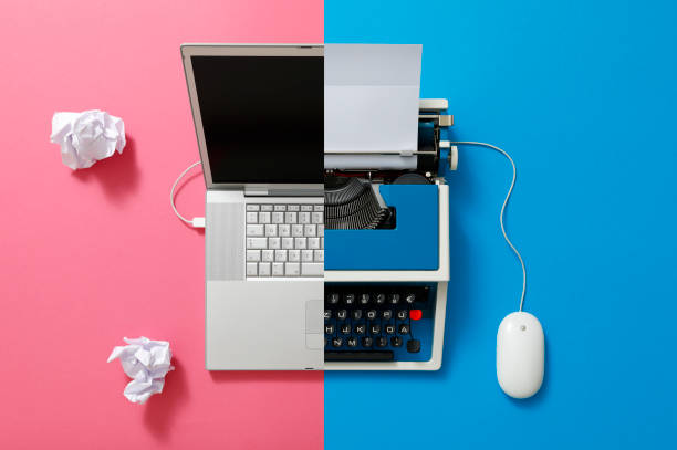 istock Digital und analog – Laptop and 80s Typewriter 1357278988