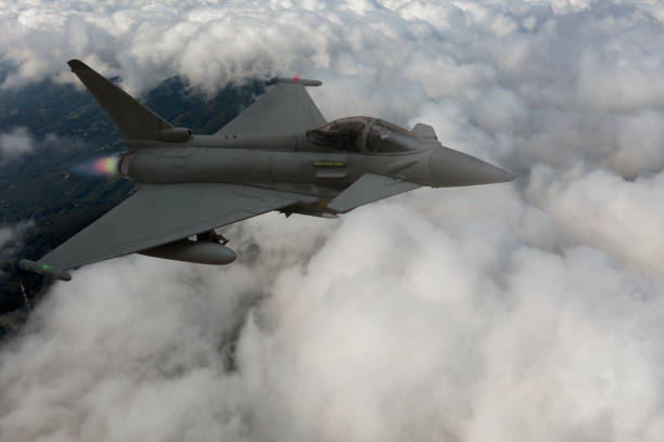 istock Jet fighters flying over the clouds. 1357281846