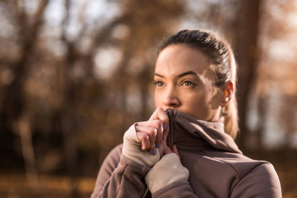 Determined athletic woman getting ready for outdoor exercise.