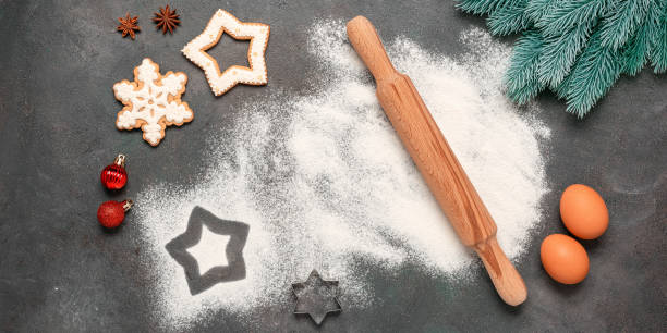 istock Christmas baking background. Flour, rolling pin, gingerbread and decorative spruce branches. Top view, flat lay. Banner 1357284267