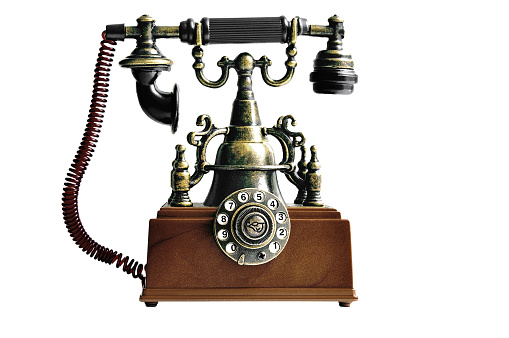 Old vintage telephone in brown color on white isolated background