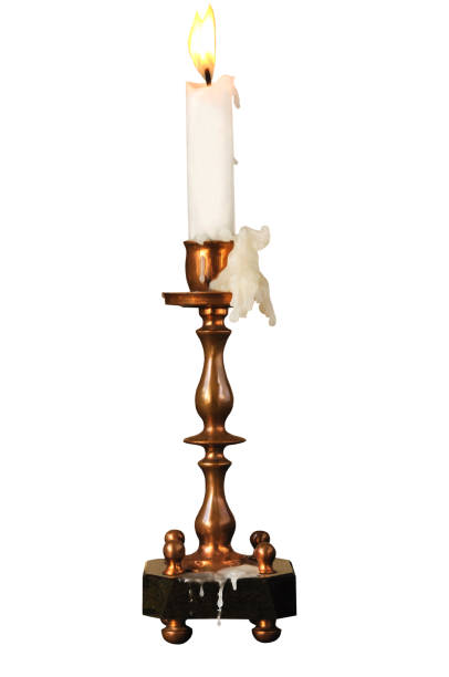 istock Copper vintage candlestick with burning candle on white isolated background 1357285072
