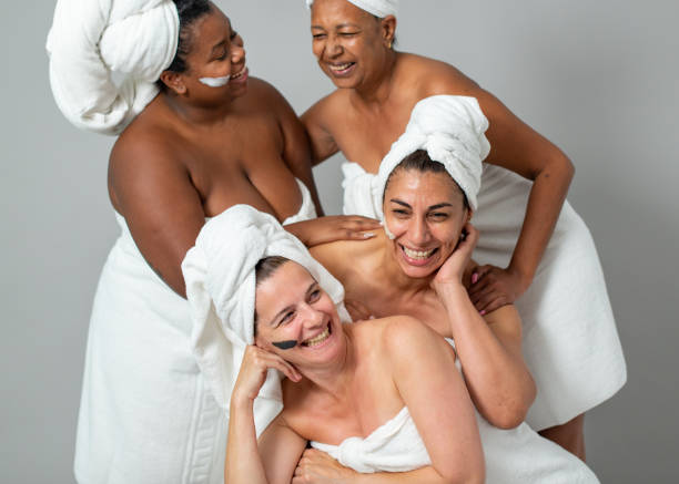istock Multiethnic females laughing during spa session 1357285312