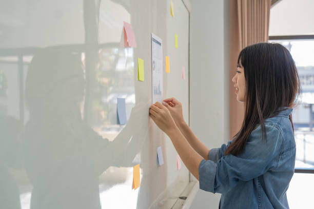 istock A female student looking at the notice posted on the board 1357289113