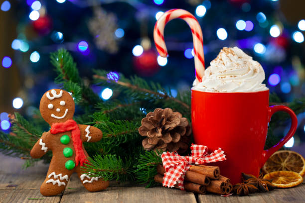 istock Christmas cappuccino and gingerbread cookies infront Christmas tree 1357290502
