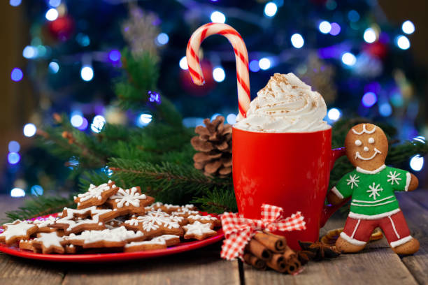 istock Christmas cappuccino and gingerbread cookies infront Christmas tree 1357291193