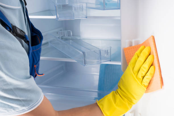 istock a man washes the refrigerator with a rag inside in rubber gloves 1357291561