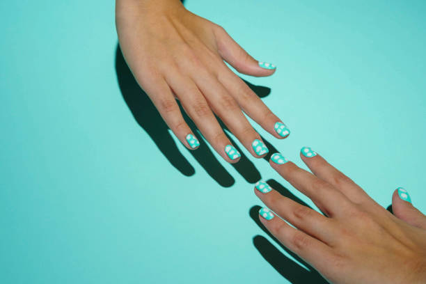 istock Two women's well-groomed beautiful hands stretch towards each other. 1357294012
