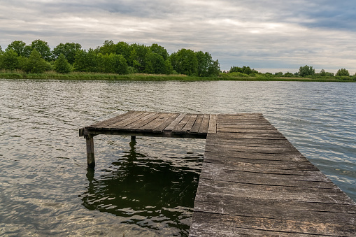 A wooden jetty leading into the Zahrener See (Lake Zahren) near Gallin, Mecklenburg-Western Pomerania, Germany