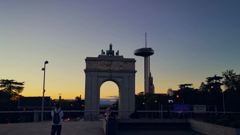 Arco de la Victoria in the Moncloa district of Madrid with lighthouse at sunset , in Spain