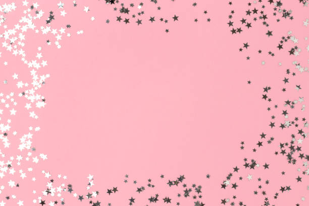 istock Border frame made of silver colored stars confetti. 1357299100