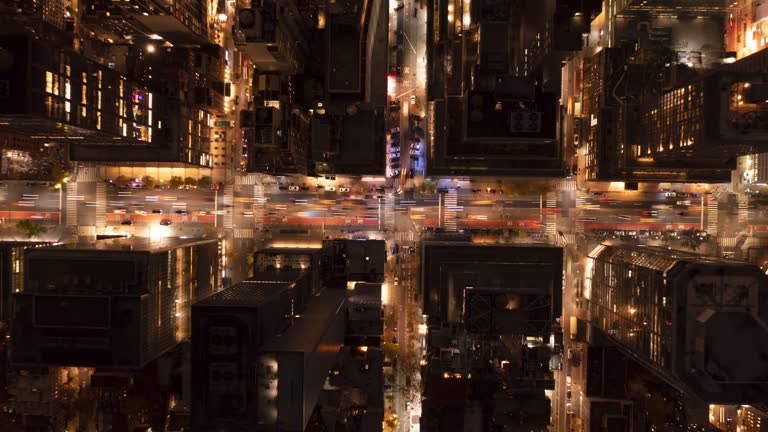 Aerial birds eye overhead top down view of traffic in streets of city. Night hyperlapse of moving vehicles. Manhattan, New York City, USA