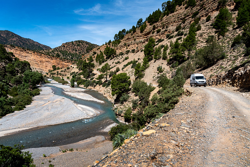 A 4x4 van progresses on the track that runs along the Assif Melloul canyon.