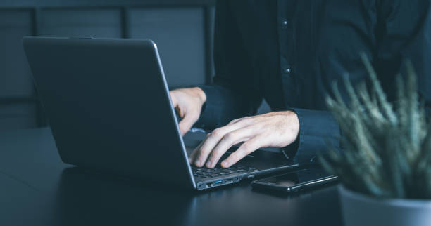 istock Businessman using a smartphone and notebook in a moddy office 1357301787