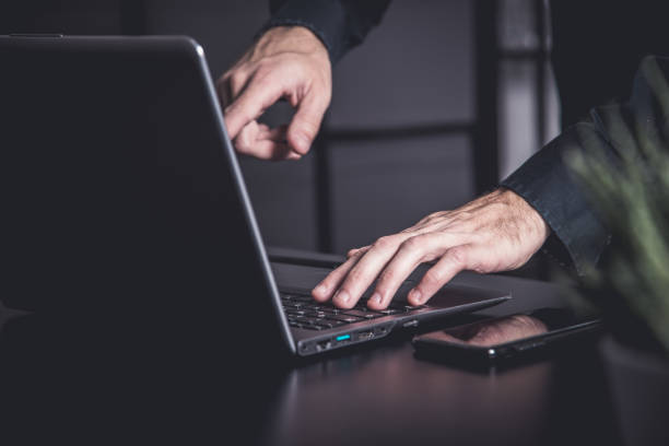 istock Businessman using a smartphone and notebook in a moddy office 1357301788