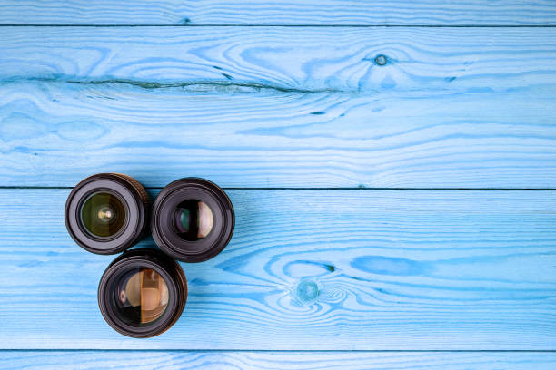 camera lenses on a wooden table top view. background and workspace for photography