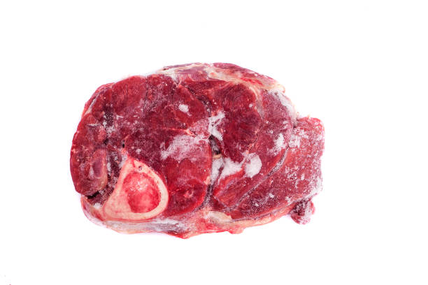 istock Frozen steak with bone. Slice of frozen beef isolated on white background. 1357309094