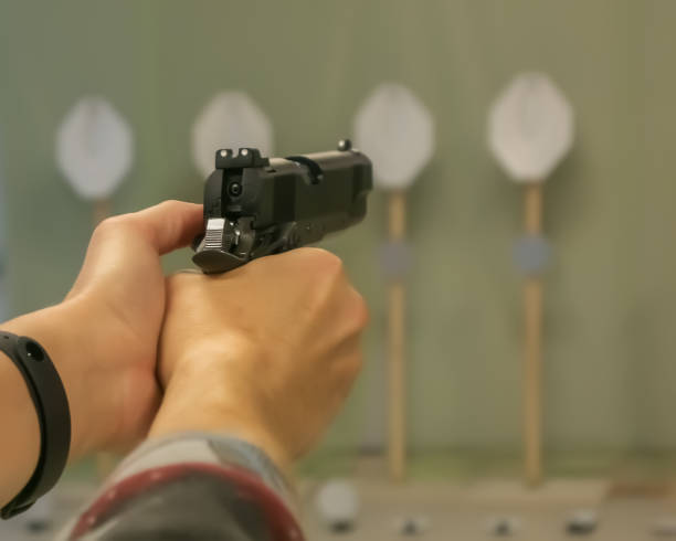 istock A pistol in female hands. Target shooting 1357310519