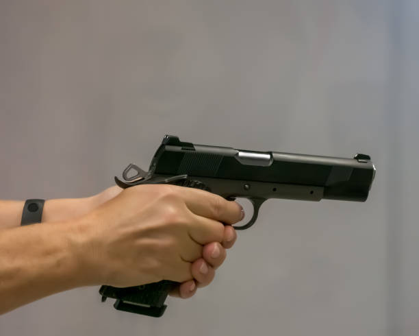 istock Gun in female hands. Shooting practice 1357310532