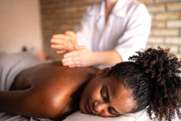 istock Young woman receiving massage on the back at a spa 1357311261