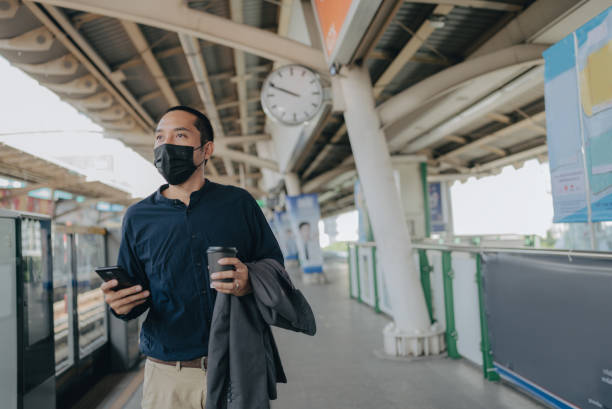 istock Businessman On Platform Waiting For Train 1357311676