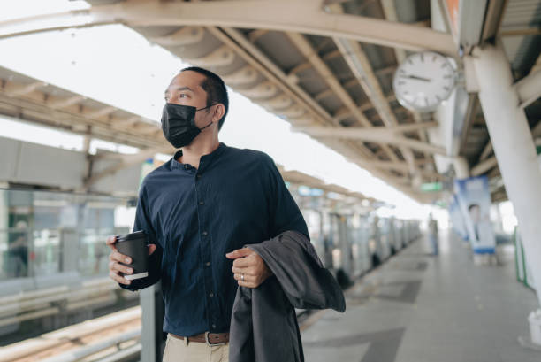 istock Businessman On Platform Waiting For Train 1357311677