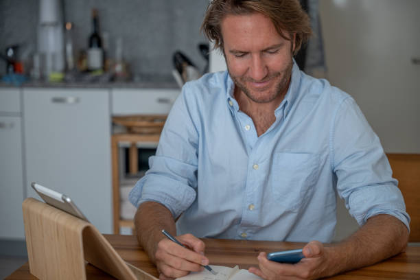 istock Young man online learning at home on digital tablet 1357311855