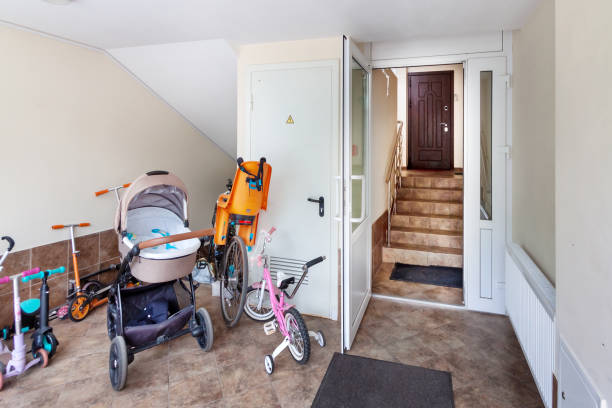 Baby pram, bicycles at the entrance residential building. Authentic houses concept. stock photo
