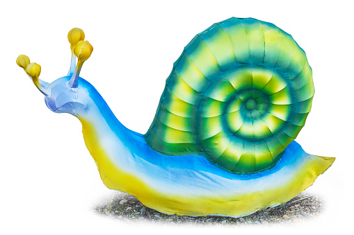 Large toy garden snail outside, isolated on white background. Clipping path (path does not include shadow).
