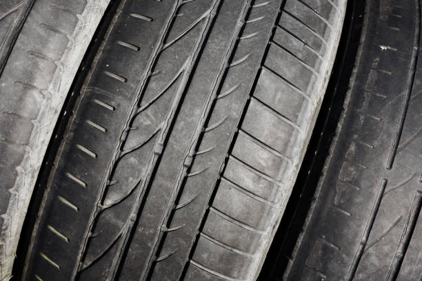 istock Used rubber tyre texture. Junkyard closeup dumped car wheel. Tire tread pattern. 1357312780